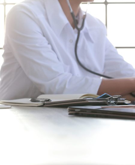 Medicine. Beautiful doctor by the table